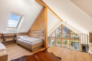 a bedroom with a bed and a large window at Chalet Bela in Bohinjska Bela