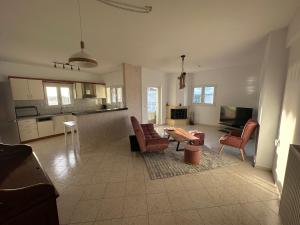 a living room with a table and chairs and a kitchen at Angela Apartments in Igoumenitsa