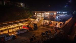 a gas station with cars parked outside at night at Matha homestay Vattavada in Vattavada