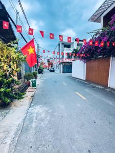 an empty street with chinese flags and flowers at Hotel Đông Ngô Biên Hòa in Ấp Thành