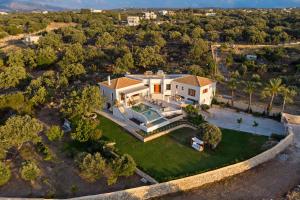 an aerial view of a house with a yard at Villa Delfini - Elevated Sea Views by etouri in Prinés
