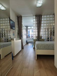a room with two beds and a large window at BLU in Puerto del Carmen