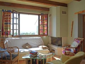 a living room with a white couch and a window at Villa in Saint Privat de Champclos with pool in Barjac