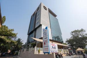a tall building with signs in front of it at Airotel in Pune