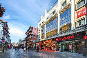 a busy city street with many shops and buildings at Ibis Beijing Tiananmen Square in Beijing