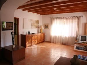 a living room with a television and a couch and a television at Holiday Home in St Josep de sa Talaia with Pool in Sant Josep de sa Talaia