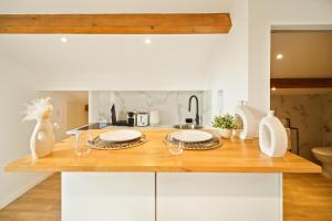 a kitchen with a wooden counter with two plates on it at Saint Tropez High standing 3 in Saint-Tropez