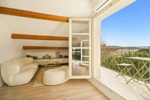 a living room with a large window and a balcony at Saint Tropez High standing 3 in Saint-Tropez