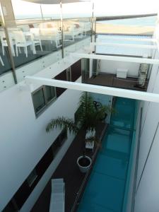 an overhead view of a balcony with a palm tree at House Barra Beach in Praia da Barra