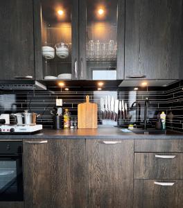 a kitchen with wooden cabinets and a counter top at Lofoten Glamping Dome in Myrland