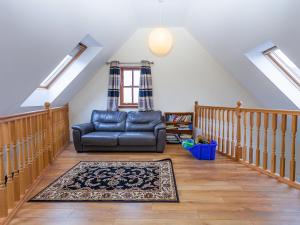 a living room with a couch and a staircase at Laurel Cottage - Ukc6256 in Linlithgow