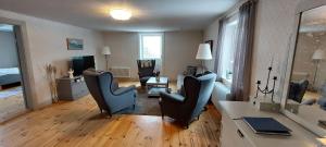a living room with two chairs and a table at Djup in Brevens Bruk