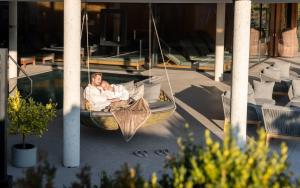 a man sitting in a boat with a baby at Gut Sonnberghof in Mittersill