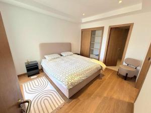 a bedroom with a bed and a chair in it at riad dar bassou in Adrouine