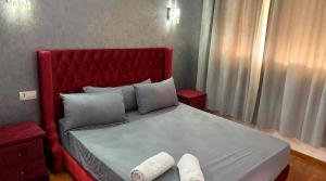 a bedroom with a large bed with two towels on it at riad dar bassou in Adrouine