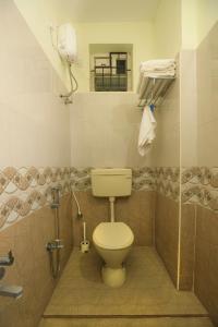 a bathroom with a toilet and a shower at Hotel I Live Inn in Chennai +28 photos