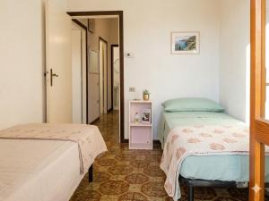 a bedroom with two beds and a small table at VILLETTA 8 - Premium Villas in Giulianova +7 photos