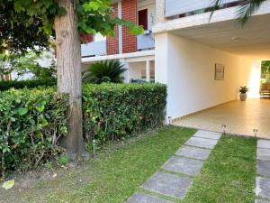 a house with a tree in the yard at VILLETTA 8 - Premium Villas in Giulianova