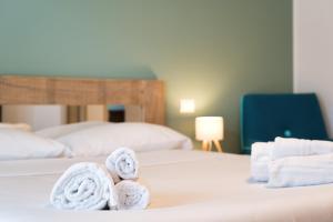a hotel room with two beds with towels at NNHouse: large terrace and marvelous view in Cassina Valsassina
