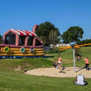 a group of people playing in a playground at domaine de litteau in Litteau