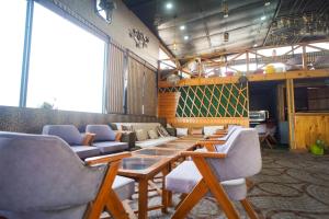a dining room with a table and chairs at AARYA Corbett Resort & SPA - 8 minutes drive to Kosi River in Nainital