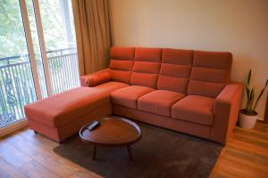 a living room with a couch and a table at La Paraiso by WhiteTrip in Vagamon