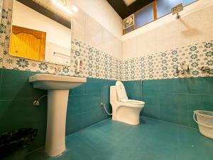 a bathroom with a toilet and a sink at AARYA Corbett Resort & SPA - 8 minutes drive to Kosi River in Nainital +35 photos
