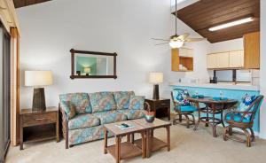 a living room with a couch and a table at The Kona Billfisher in Kailua-Kona