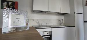 a kitchen with a framed picture on the counter at SISTERS GUEST HOUSE 2 in Somma Lombardo +10 photos