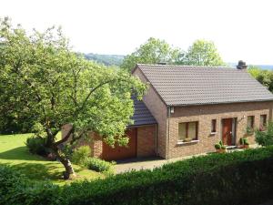 a brick house with a tree in front of it at Modern Holiday Home in Stavelot with Fireplace in Stavelot