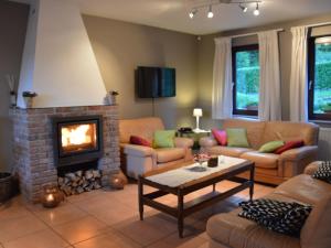 a living room with a couch and a fireplace at Modern Holiday Home in Stavelot with Fireplace in Stavelot