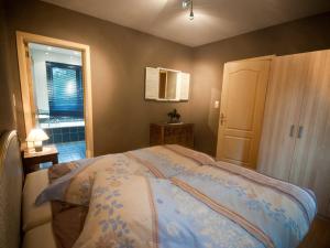 a bedroom with a bed and a window at Modern Holiday Home in Stavelot with Fireplace in Stavelot