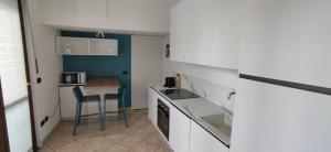 a small kitchen with a table and a counter top at SISTERS GUEST HOUSE 2 in Somma Lombardo