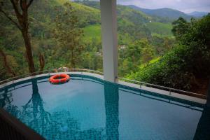 a swimming pool with a view of a mountain at La Paraiso by WhiteTrip in Vagamon