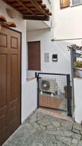 a building with a gate with a cat in it at SISTERS GUEST HOUSE 2 in Somma Lombardo