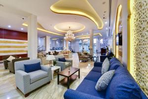hol hotelu z niebieskimi kanapami i krzesłami w obiekcie Golden Dune Hotel AlFayhaa w Rijadzie