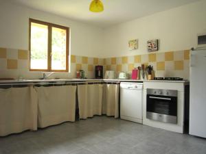 a kitchen with towels hanging on the counters and a sink at Classic Cottage in Le Bourg Dun with Garden in Le Bourg-Dun