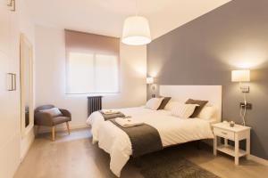 A bed or beds in a room at Granada Home Centro