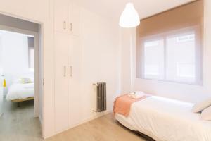 A bed or beds in a room at Granada Home Centro
