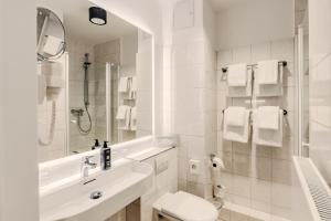 a white bathroom with a sink and a toilet at Apartment-Hotel Hamburg Mitte in Hamburg +176 photos
