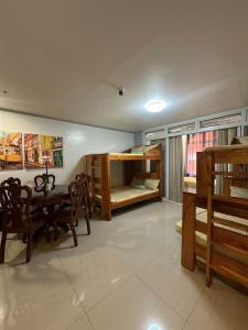 a room with a table and chairs and bunk beds at Your Quiet Home with Unbeatable location in Baguio