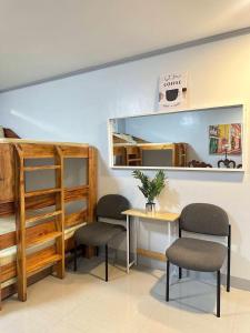 a room with a table and two chairs and a mirror at Your Quiet Home with Unbeatable location in Baguio +1 photo
