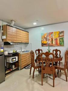 a kitchen with a table and chairs in a room at Your Quiet Home with Unbeatable location in Baguio