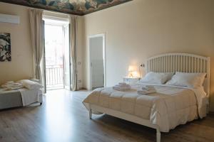 a white bedroom with a large bed and a window at B&B Matteo Bonello - Fianco Cattedrale in Palermo +50 photos