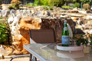 a bottle of beer sitting on top of a table at Fairlight Luxe Escape 4BR with Parking in Killara