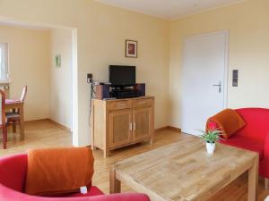 a living room with a couch and a tv at Peaceful Holiday Home in Rascheid near Forest in Geisfeld