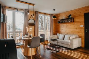 a living room with a couch and a table at Tiny house v Moravském Berouně in Moravský Beroun