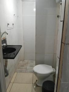 a small bathroom with a toilet and a sink at Aconchego de Olinda in Olinda