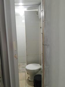 a bathroom with a white toilet in a room at Aconchego de Olinda in Olinda +16 photos