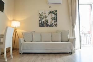 a couch in a living room with a picture on the wall at B&B Matteo Bonello - Fianco Cattedrale in Palermo